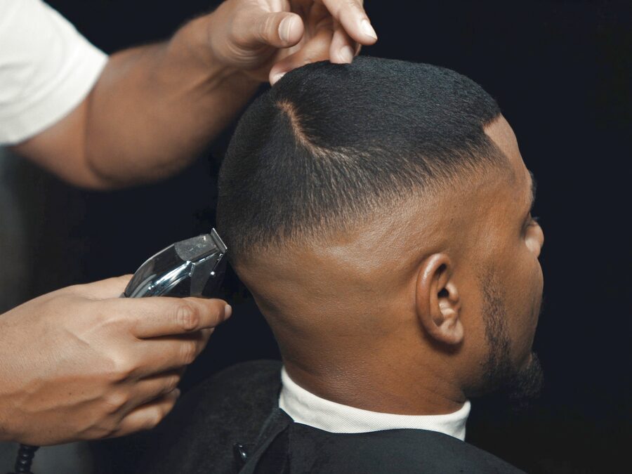 Barber blending a clipper fade at The Chair Barbershop in Chicago